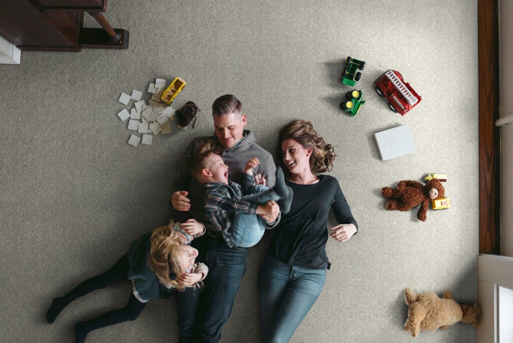 Happy family on carpet | Discount Carpet Warehouse